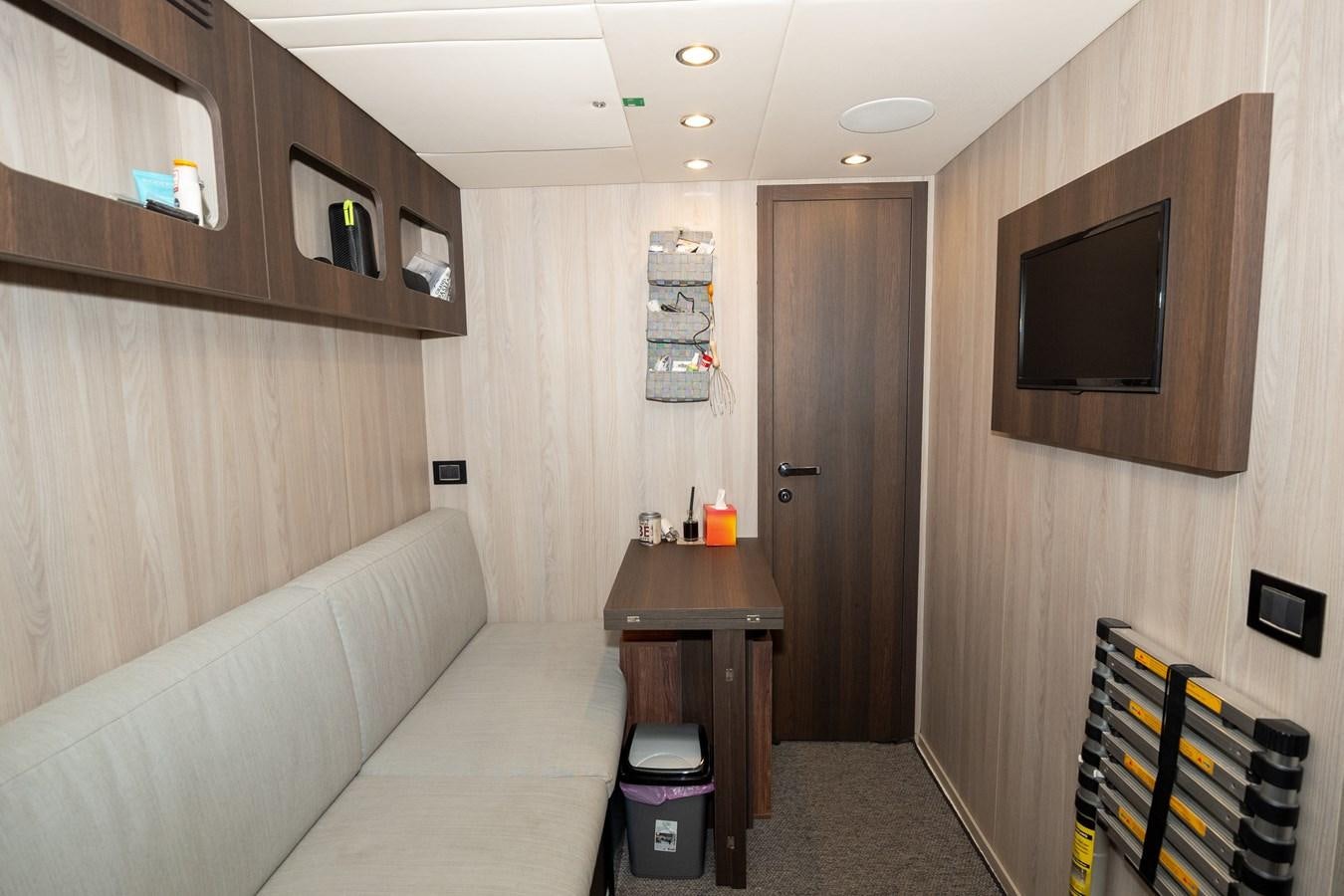 a living room with a couch and tv aboard CLOUDY BAY Yacht for Sale