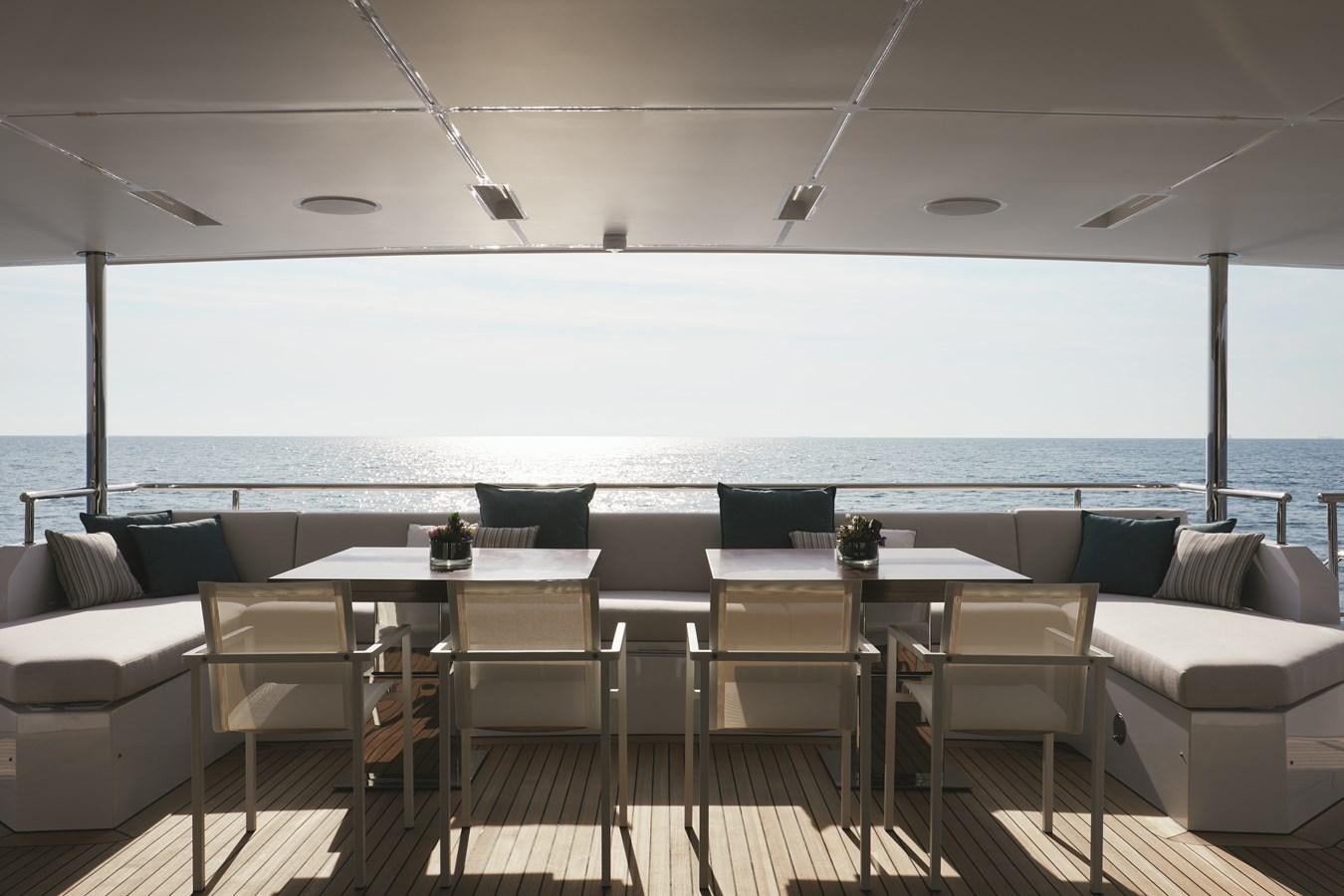 a room with a table and chairs aboard BAMBOO Yacht for Sale