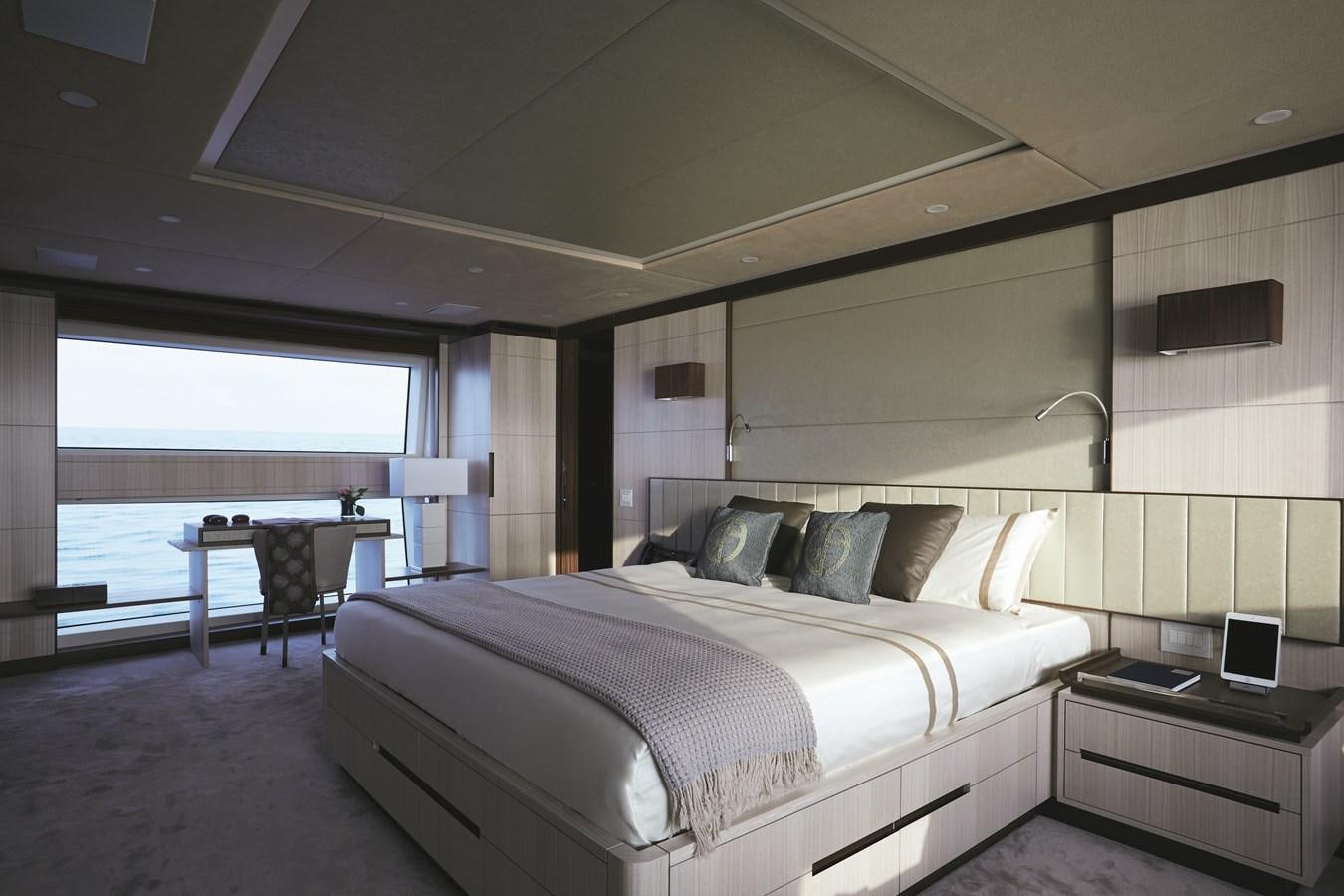 a bedroom with a bed and a desk aboard BAMBOO Yacht for Sale