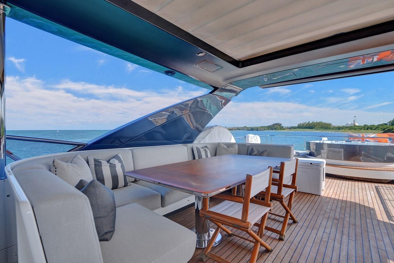 a table and chairs on a deck aboard ENCHANTE Yacht for Sale