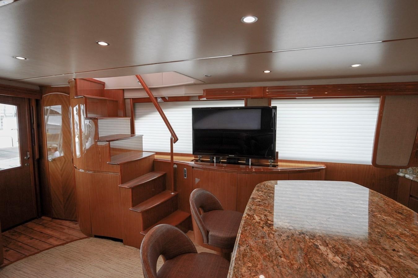 a room with a tv and a table aboard BENEDETTA Yacht for Sale
