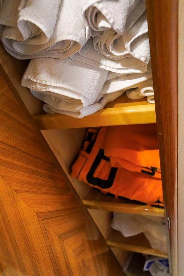 a closet with clothes and a shelf aboard BENEDETTA Yacht for Sale