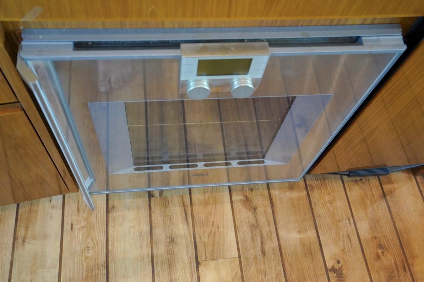 a metal cabinet with a clear door aboard BENEDETTA Yacht for Sale