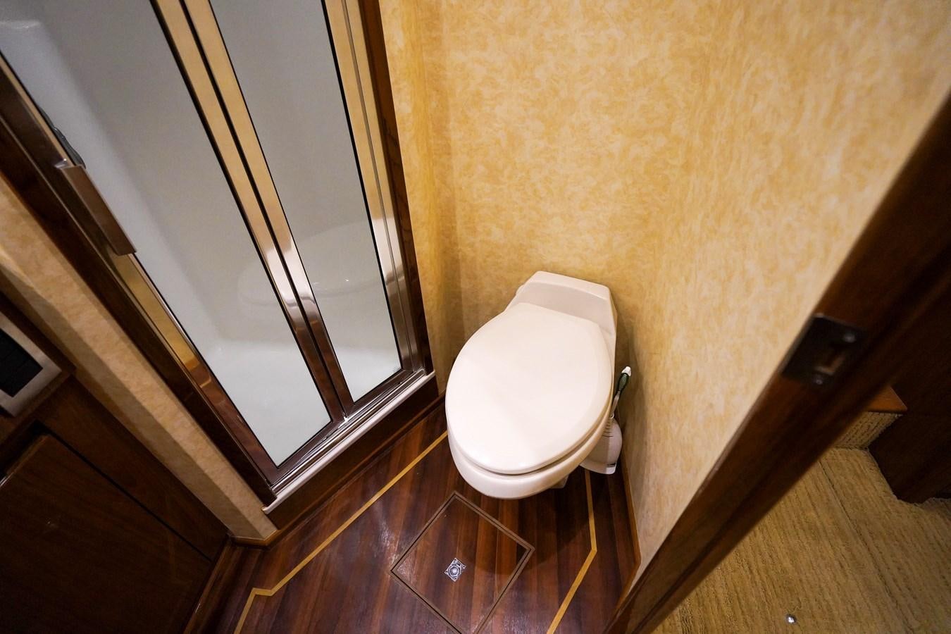 a bathroom with a toilet and a glass door aboard BENEDETTA Yacht for Sale