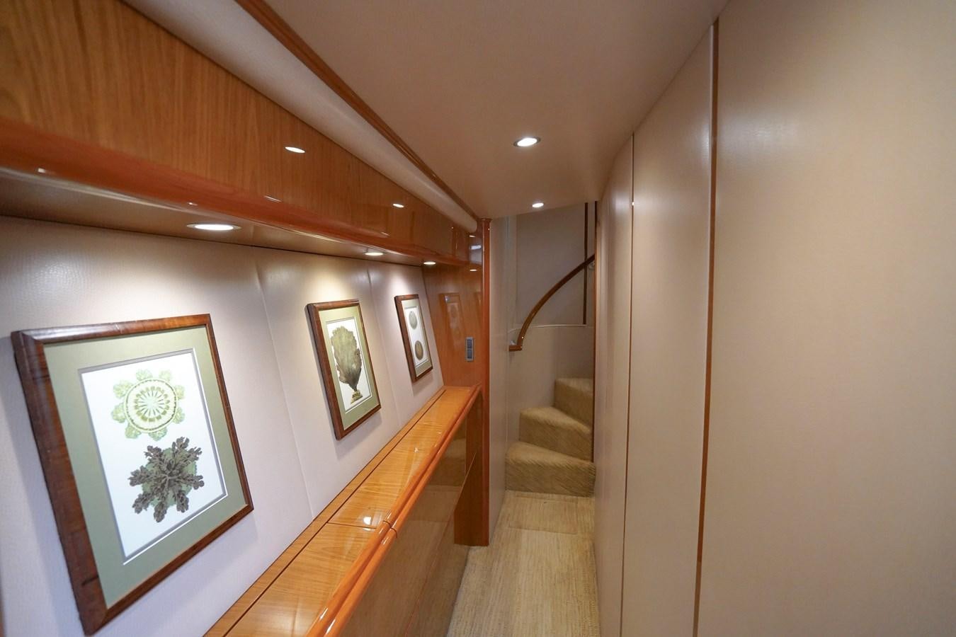 a hallway with paintings on the wall aboard BENEDETTA Yacht for Sale