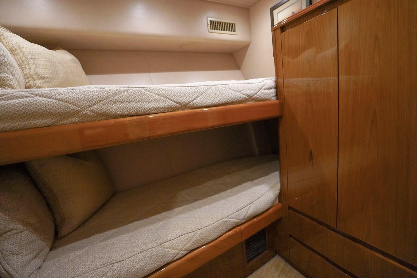 a bed with a wooden headboard aboard BENEDETTA Yacht for Sale
