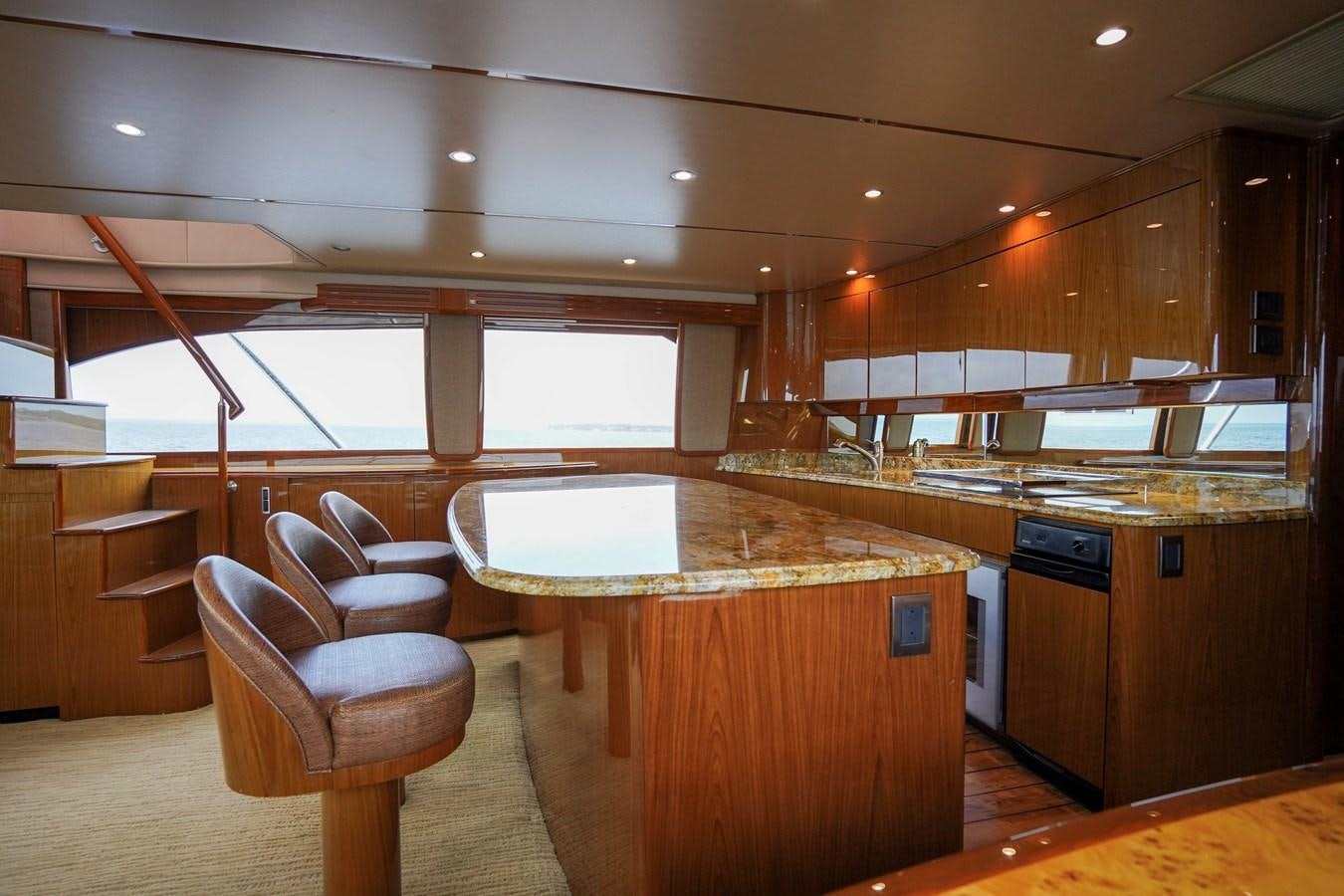 a kitchen with a bar and a table aboard BENEDETTA Yacht for Sale