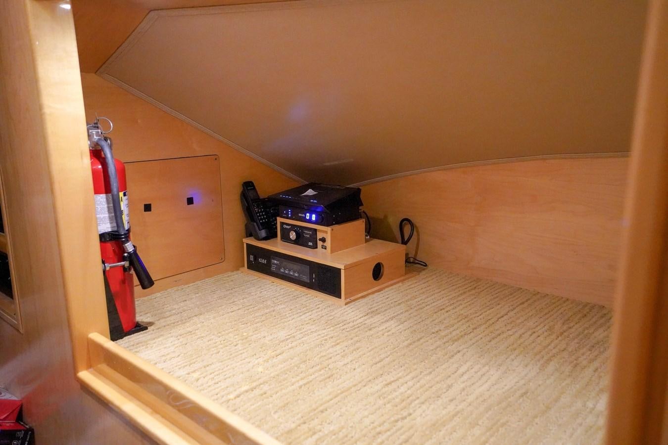 a room with a bed and a shelf with a guitar on it aboard BENEDETTA Yacht for Sale