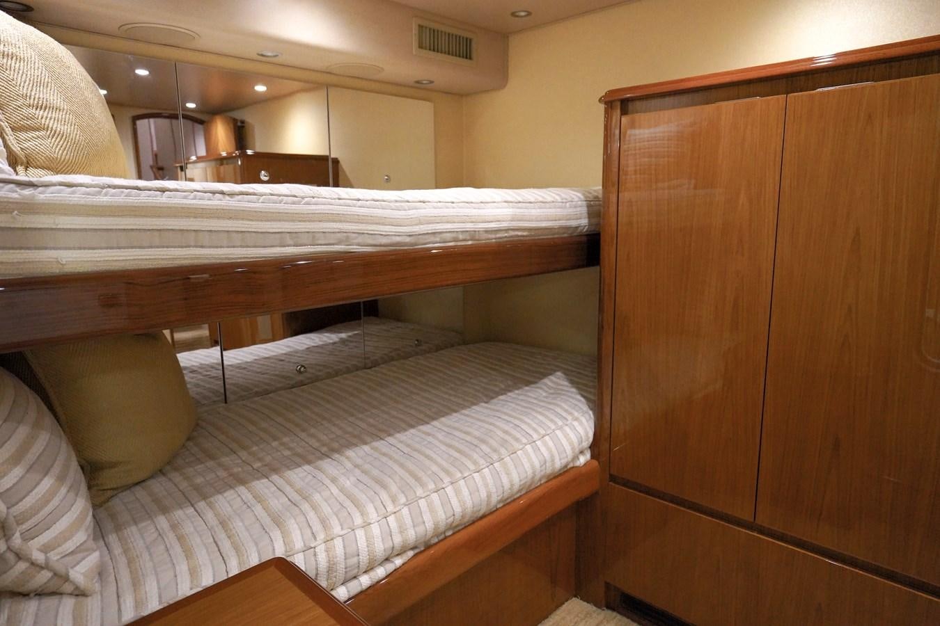 a bed with a wooden headboard aboard BENEDETTA Yacht for Sale