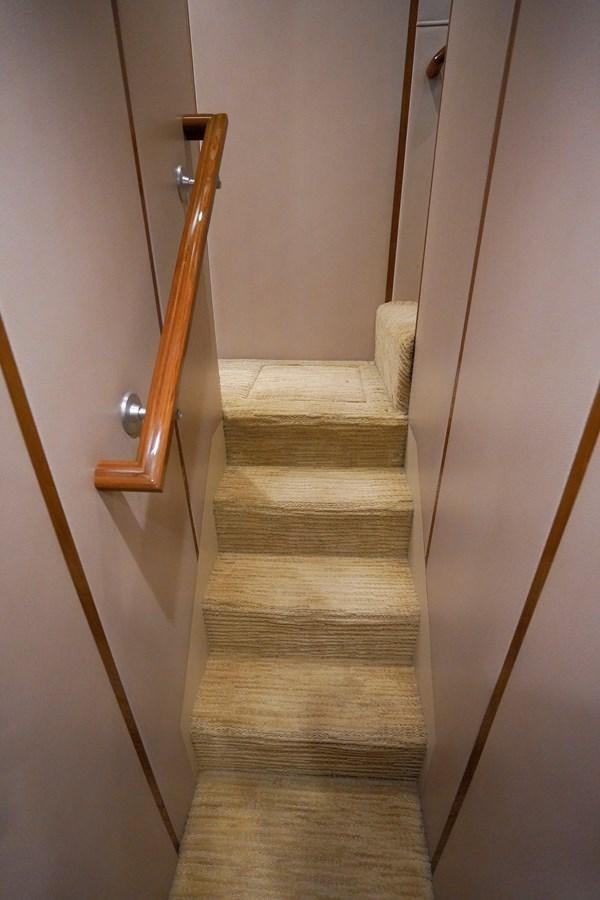 a wooden staircase with a wood railing aboard BENEDETTA Yacht for Sale