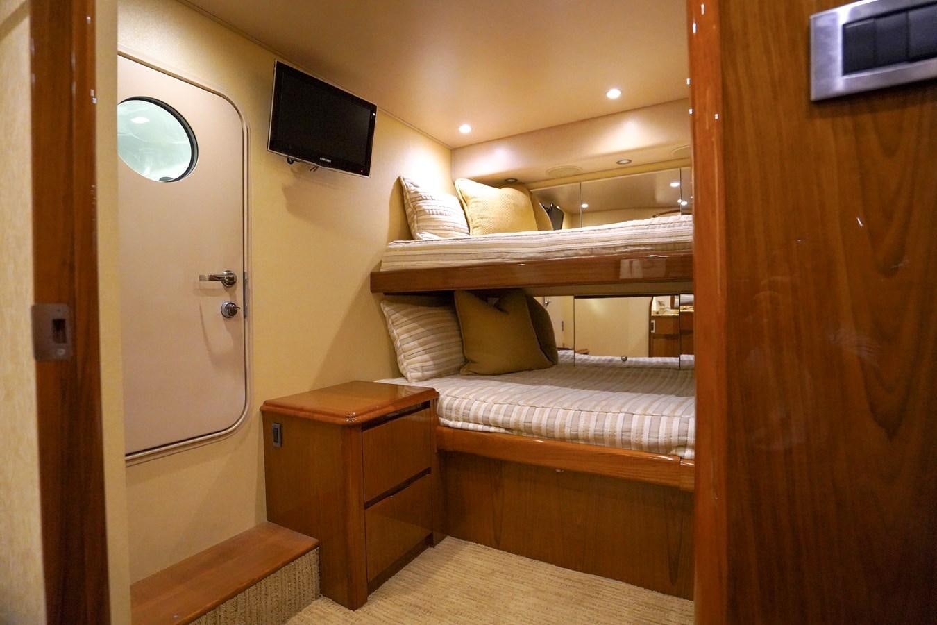 a room with a bed and a television aboard BENEDETTA Yacht for Sale