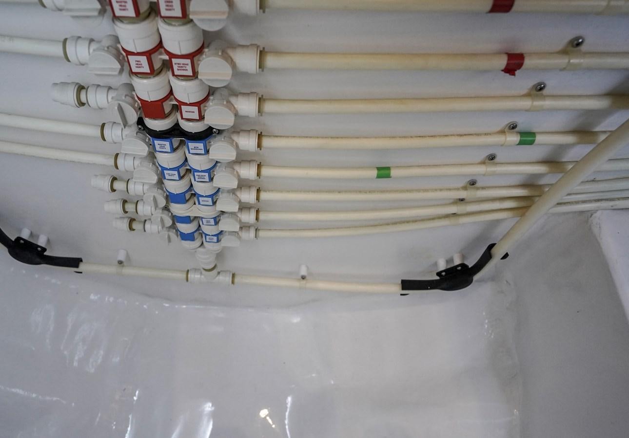 a white wall with wires and a few colorful and white wires aboard BENEDETTA Yacht for Sale