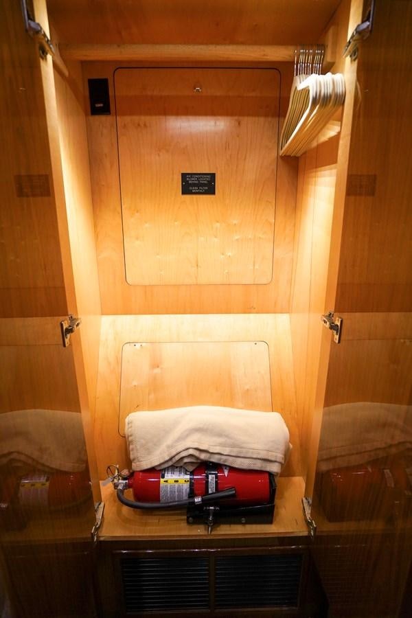 a closet with clothes and a swinger aboard BENEDETTA Yacht for Sale