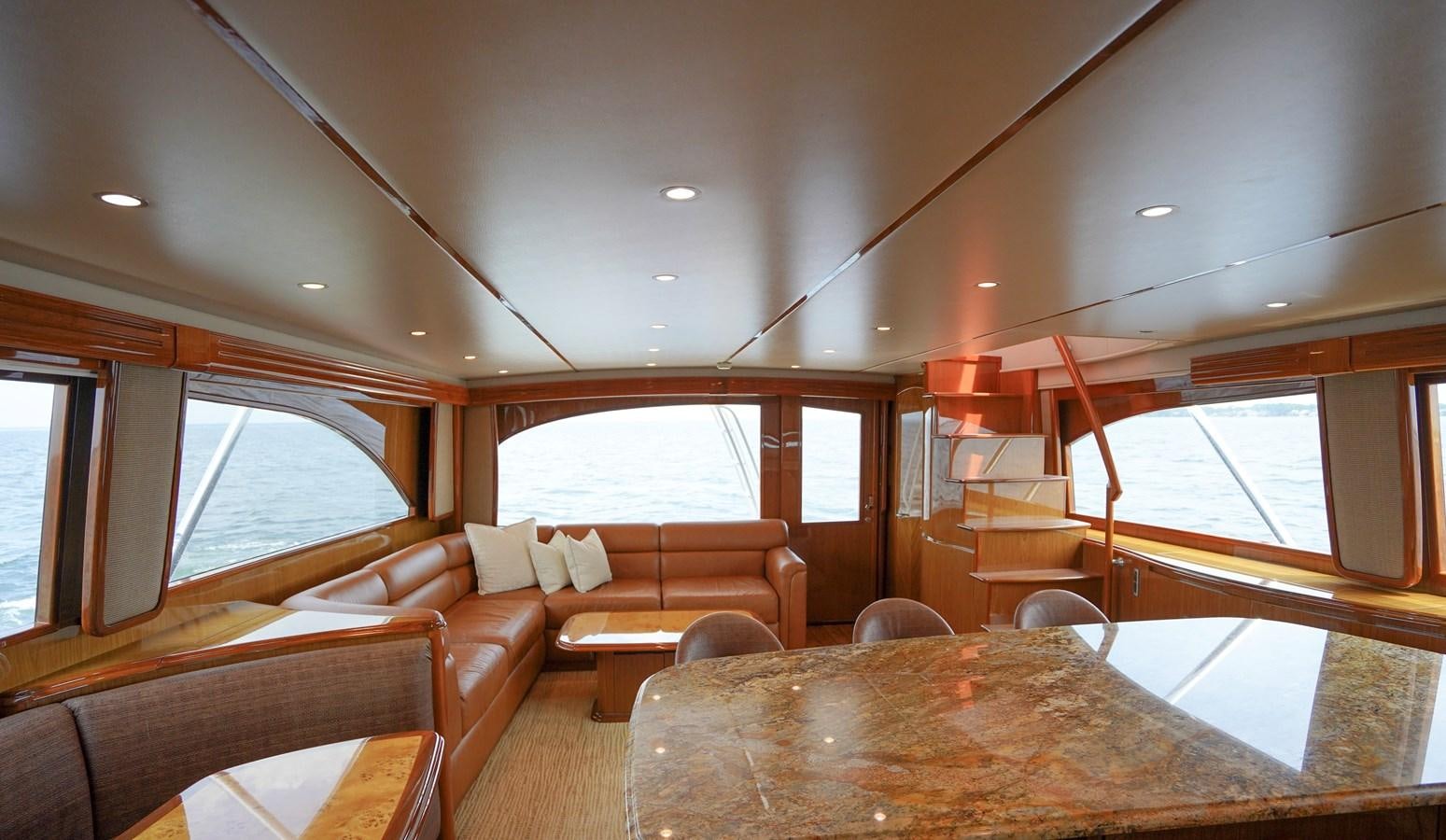 a living room with a table and couches aboard BENEDETTA Yacht for Sale