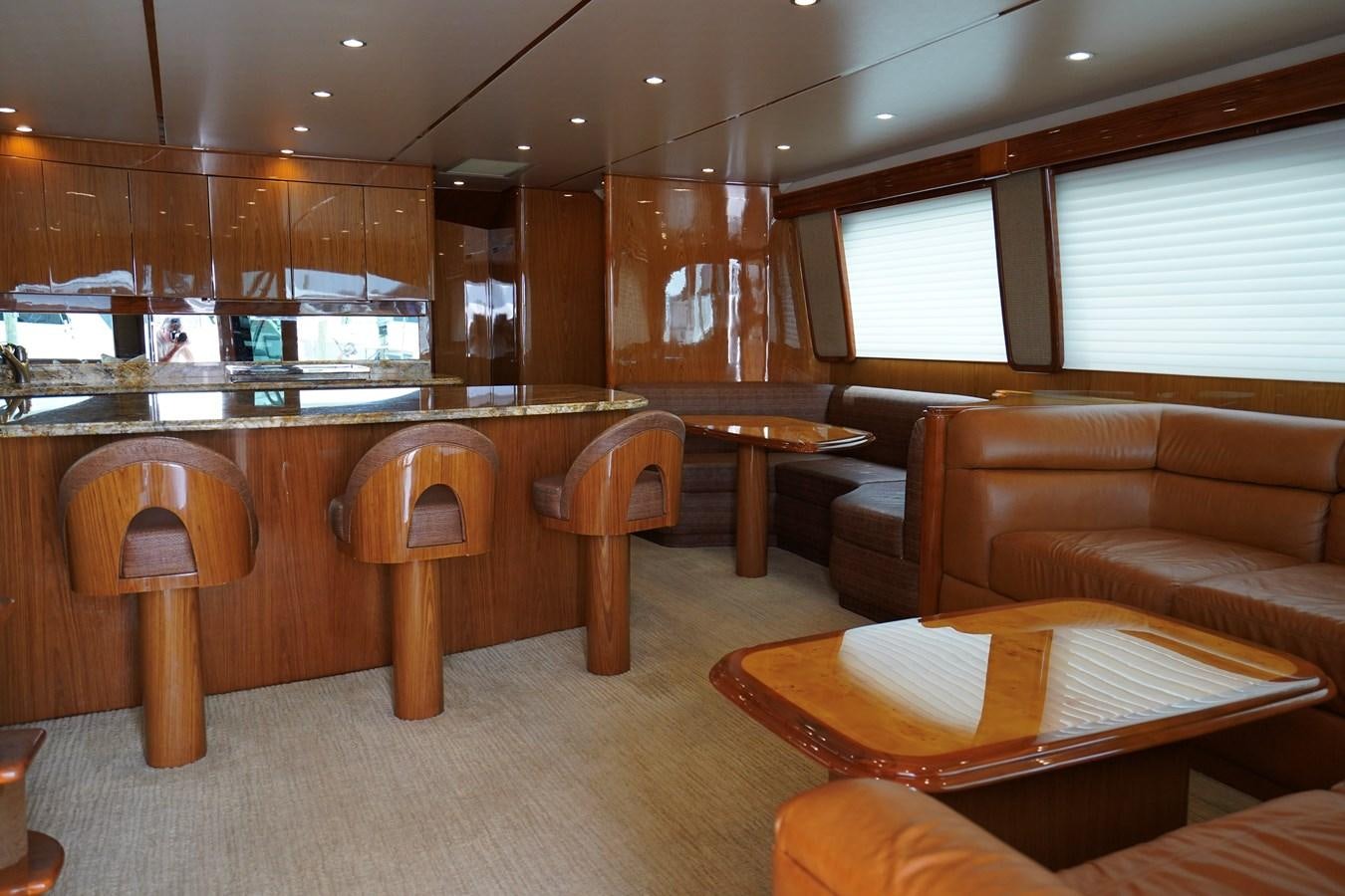 a large room with a bar and chairs aboard BENEDETTA Yacht for Sale