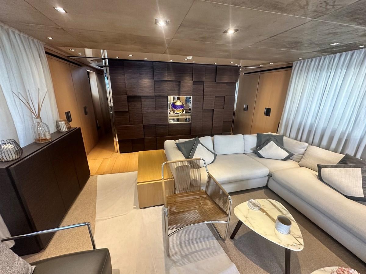 a living room with a couch and a table aboard SL 94' Yacht for Sale