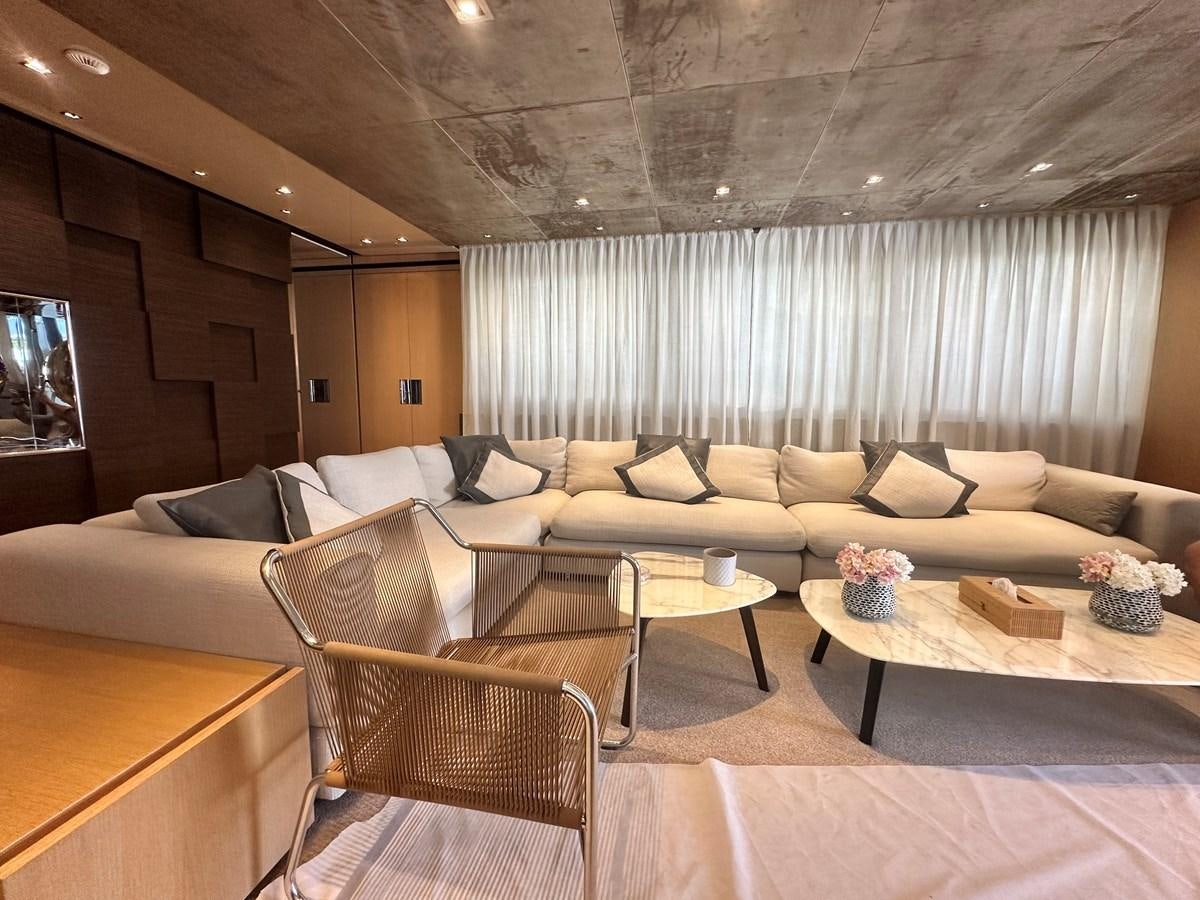 a living room with a couch and a coffee table aboard SL 94' Yacht for Sale