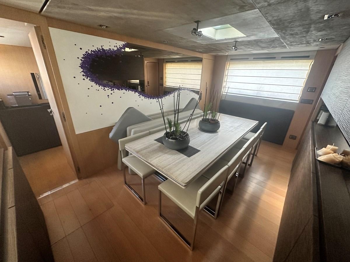 a room with a table and chairs aboard SL 94' Yacht for Sale