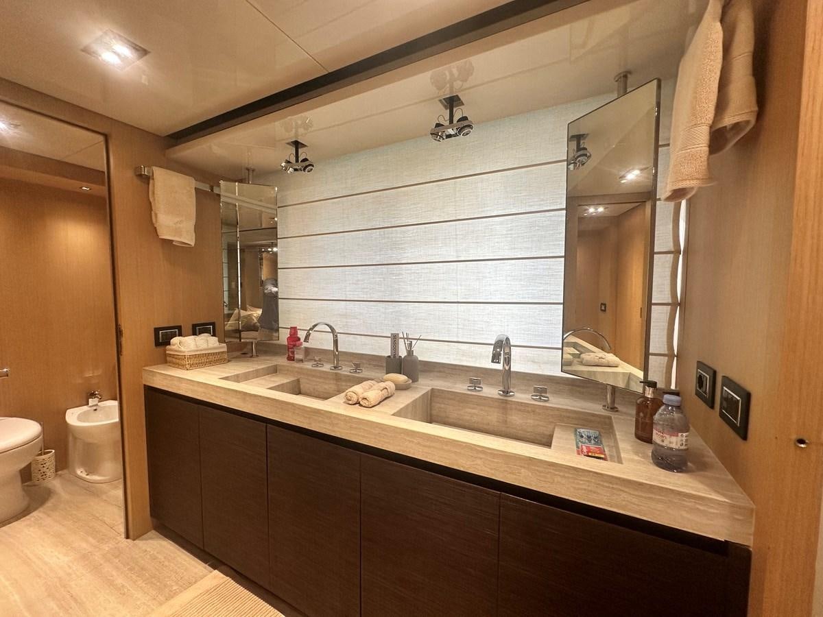 a bathroom with a large mirror aboard SL 94' Yacht for Sale