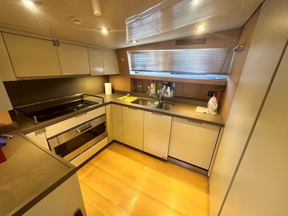 a kitchen with white cabinets aboard SL 94' Yacht for Sale