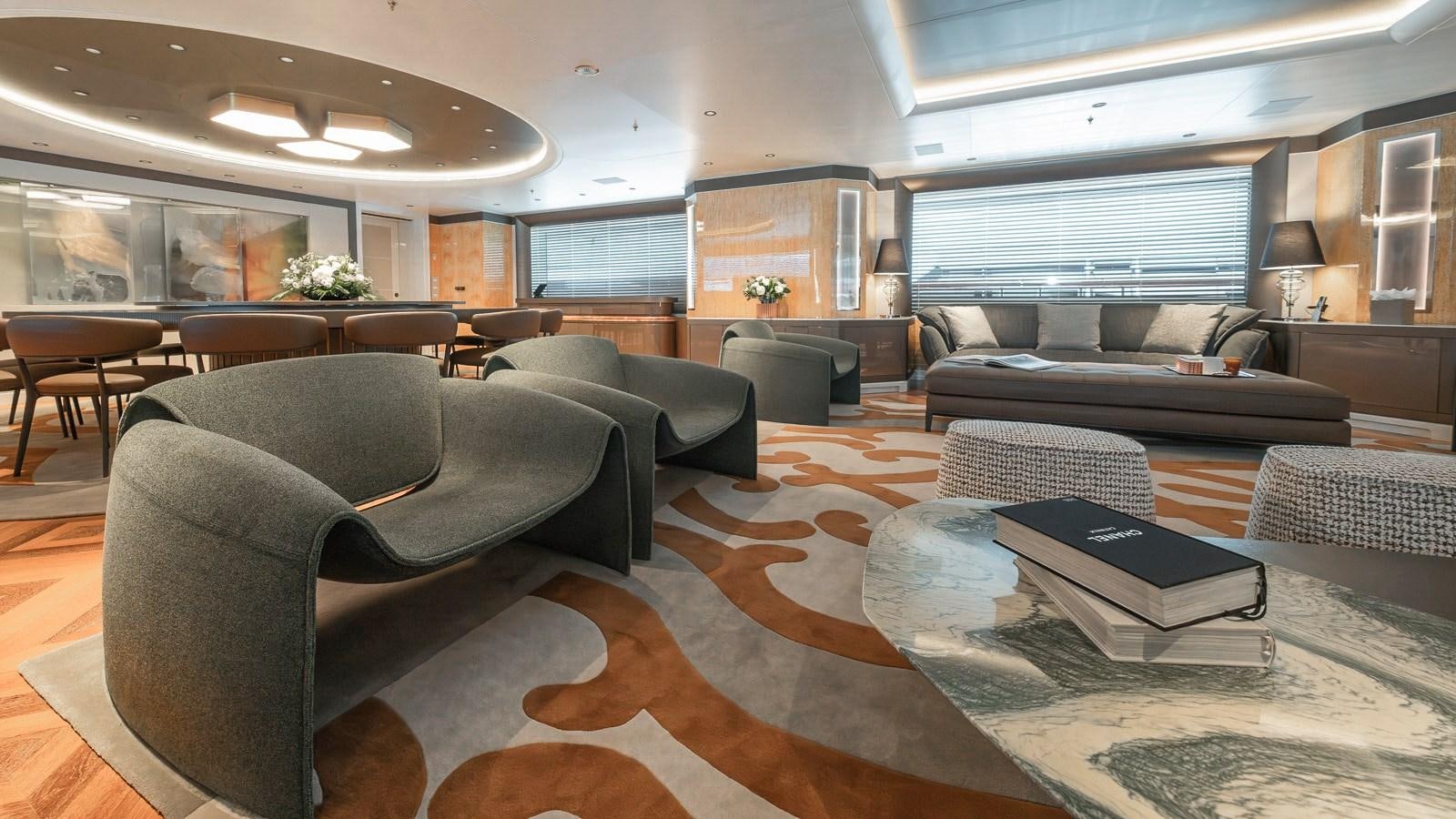 a large living room with leather couches and a coffee table aboard AELIA Yacht for Sale