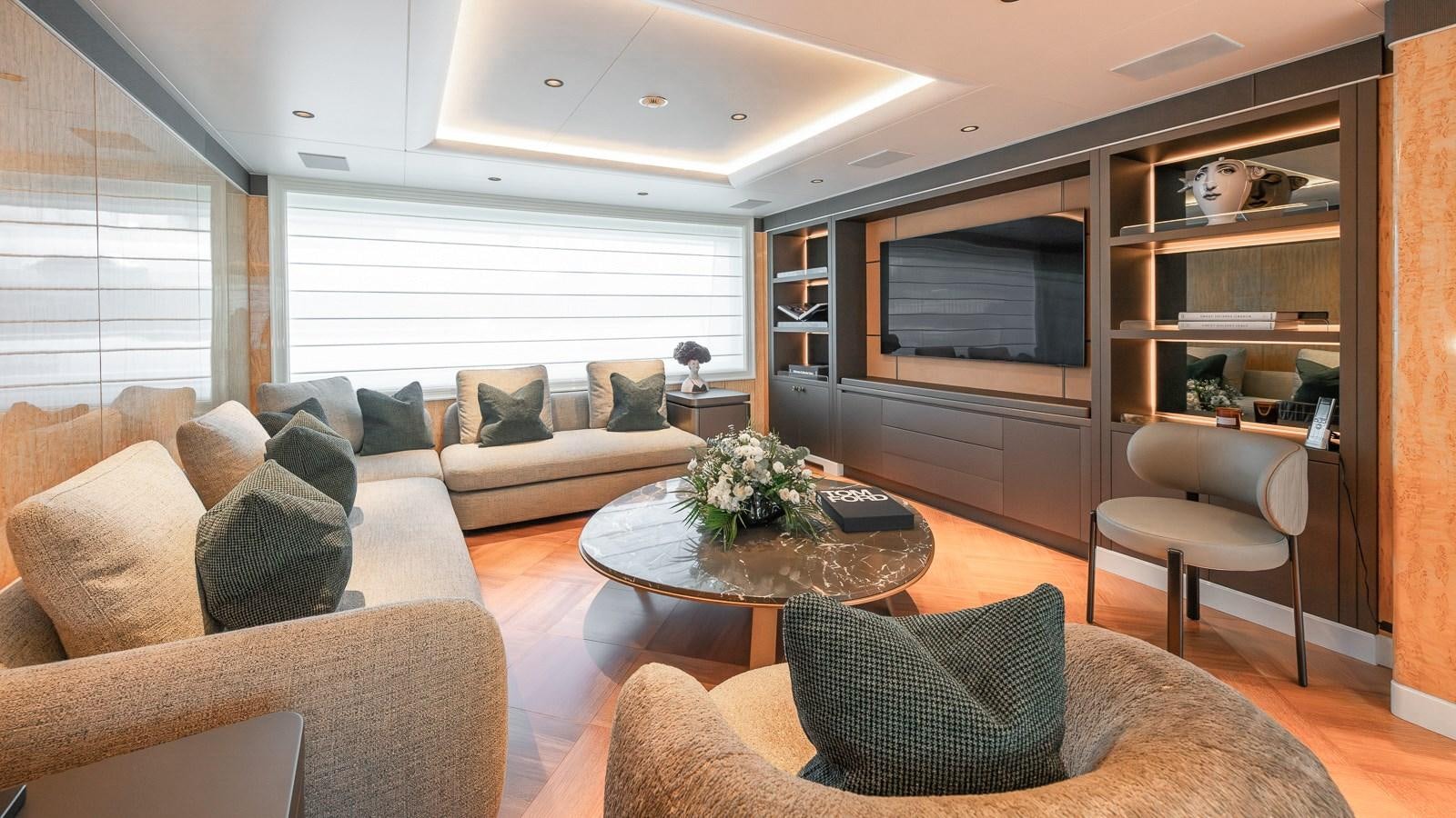 a living room with a couch and a television aboard AELIA Yacht for Sale