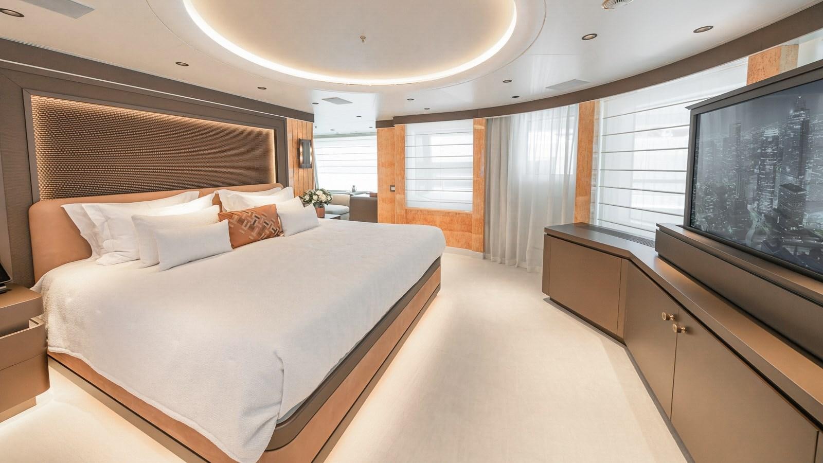 a room with a bed and a television aboard AELIA Yacht for Sale