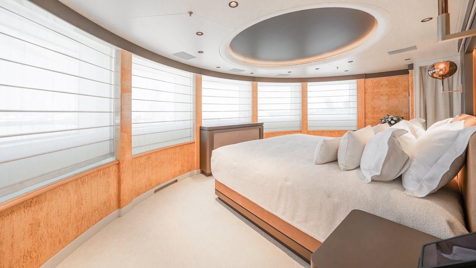 a room with a bed and a round ceiling fan aboard AELIA Yacht for Sale