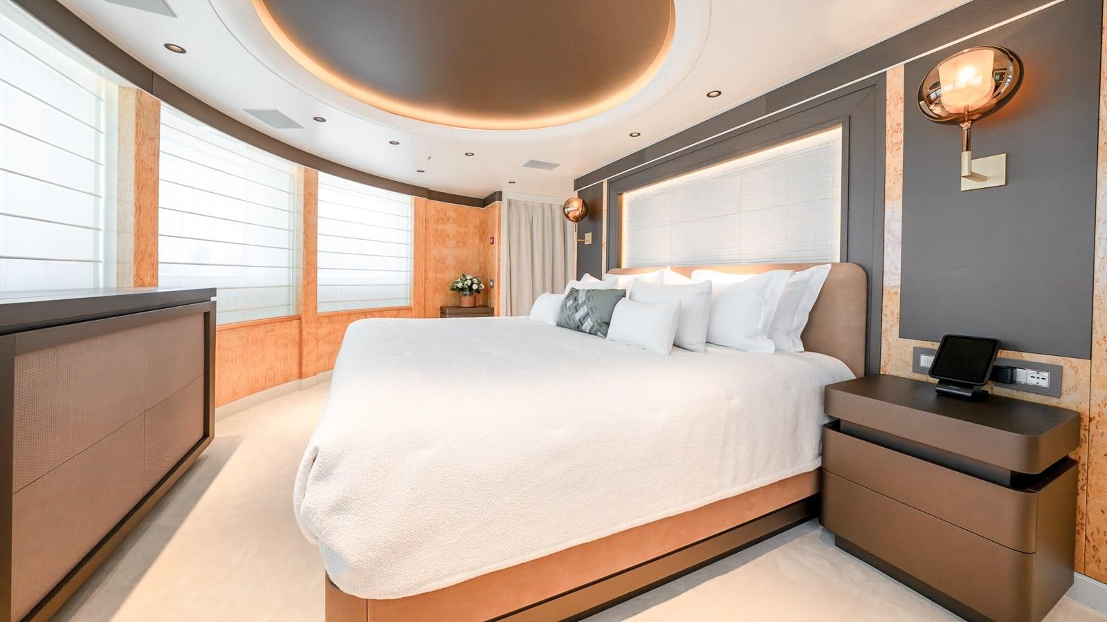 a bedroom with a bed and a tv aboard AELIA Yacht for Sale