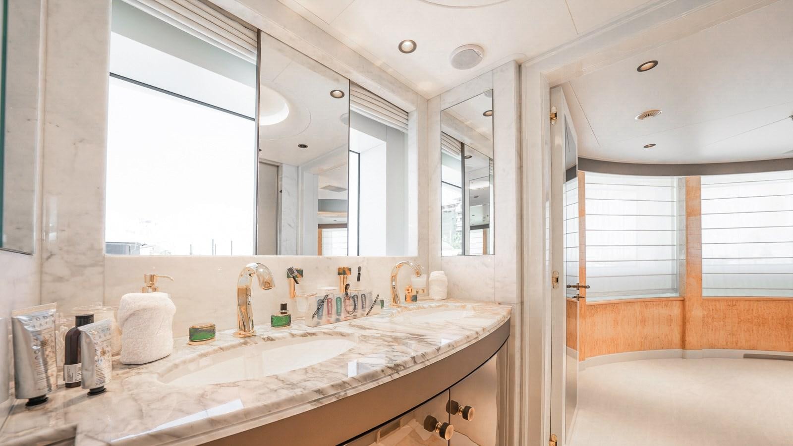 a bathroom with a countertop sink and a large mirror aboard AELIA Yacht for Sale