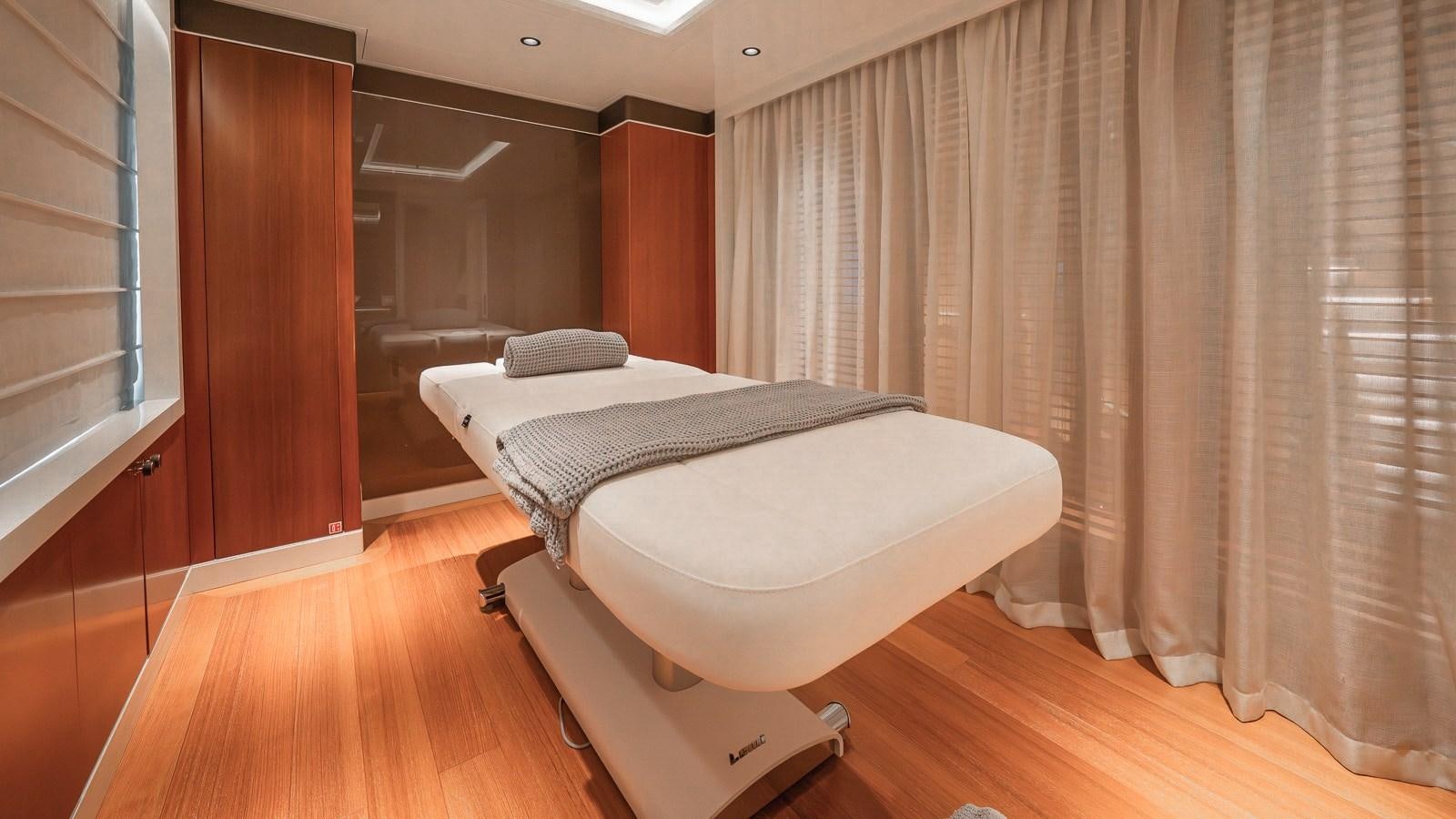 a room with a bed and a window aboard AELIA Yacht for Sale