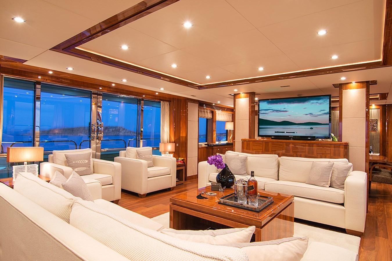 a living room with a large screen aboard PATHOS Yacht for Sale