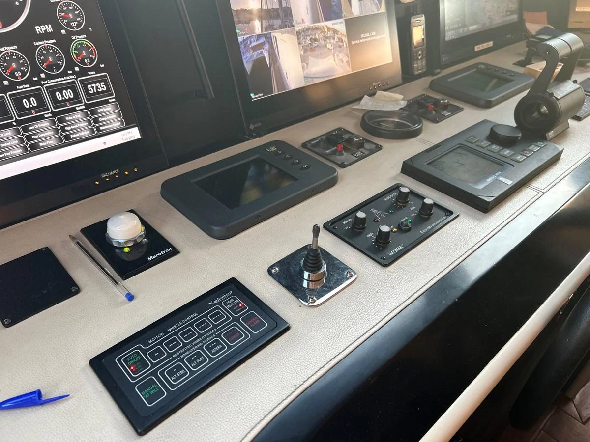 a desk with a computer and other electronic devices on it aboard WHISPER Yacht for Sale
