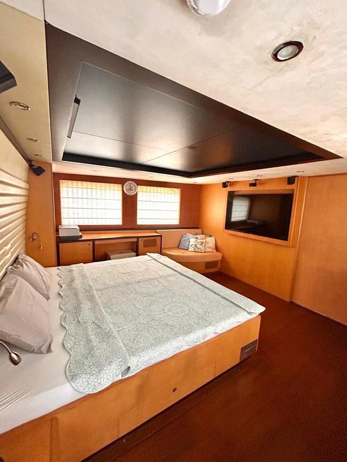 a bed with a round mirror above it aboard WHISPER Yacht for Sale