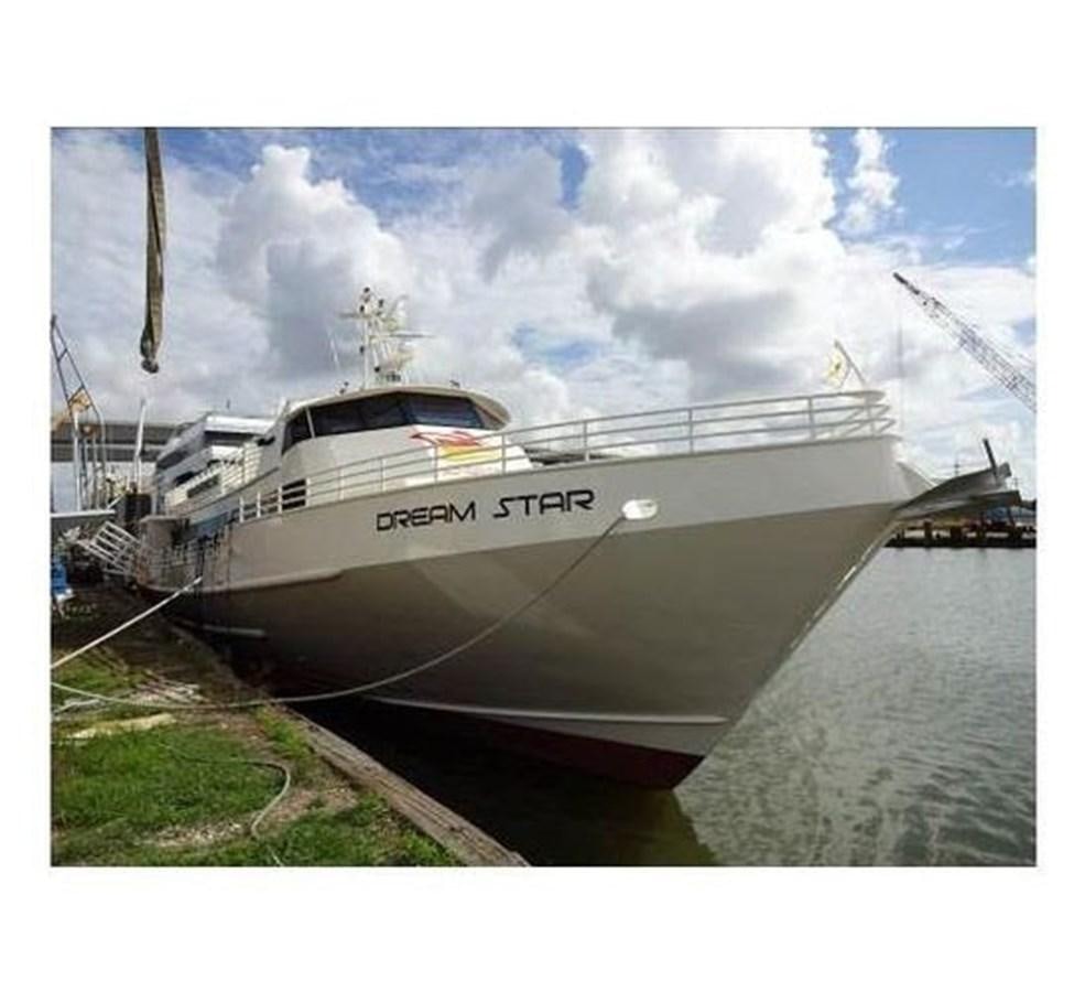 a white boat on a dock aboard DREAM STAR Yacht for Sale