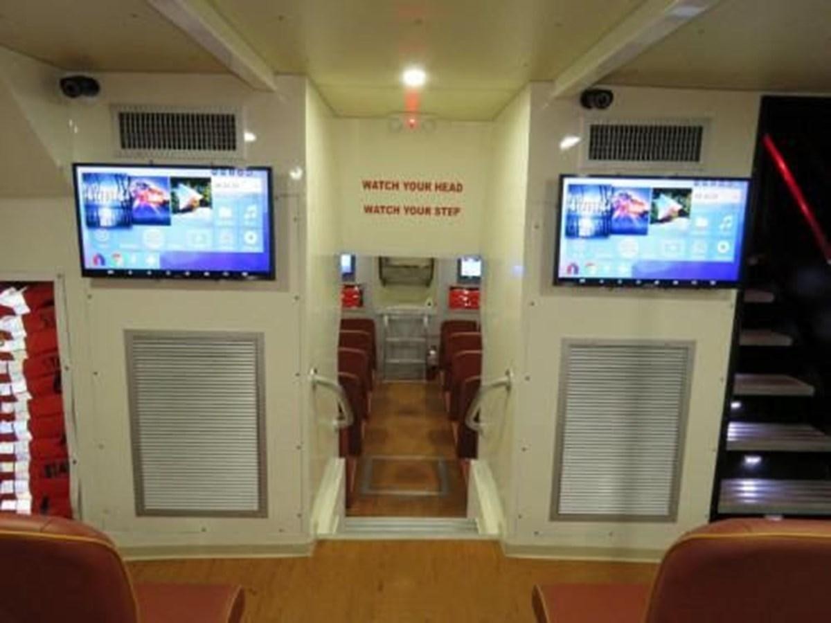 a room with a tv and furniture aboard DREAM STAR Yacht for Sale