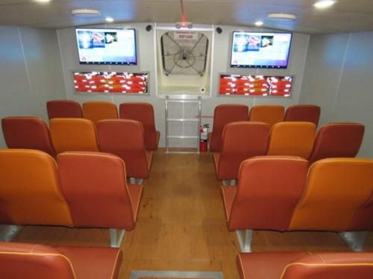 a room with chairs and a tv aboard DREAM STAR Yacht for Sale