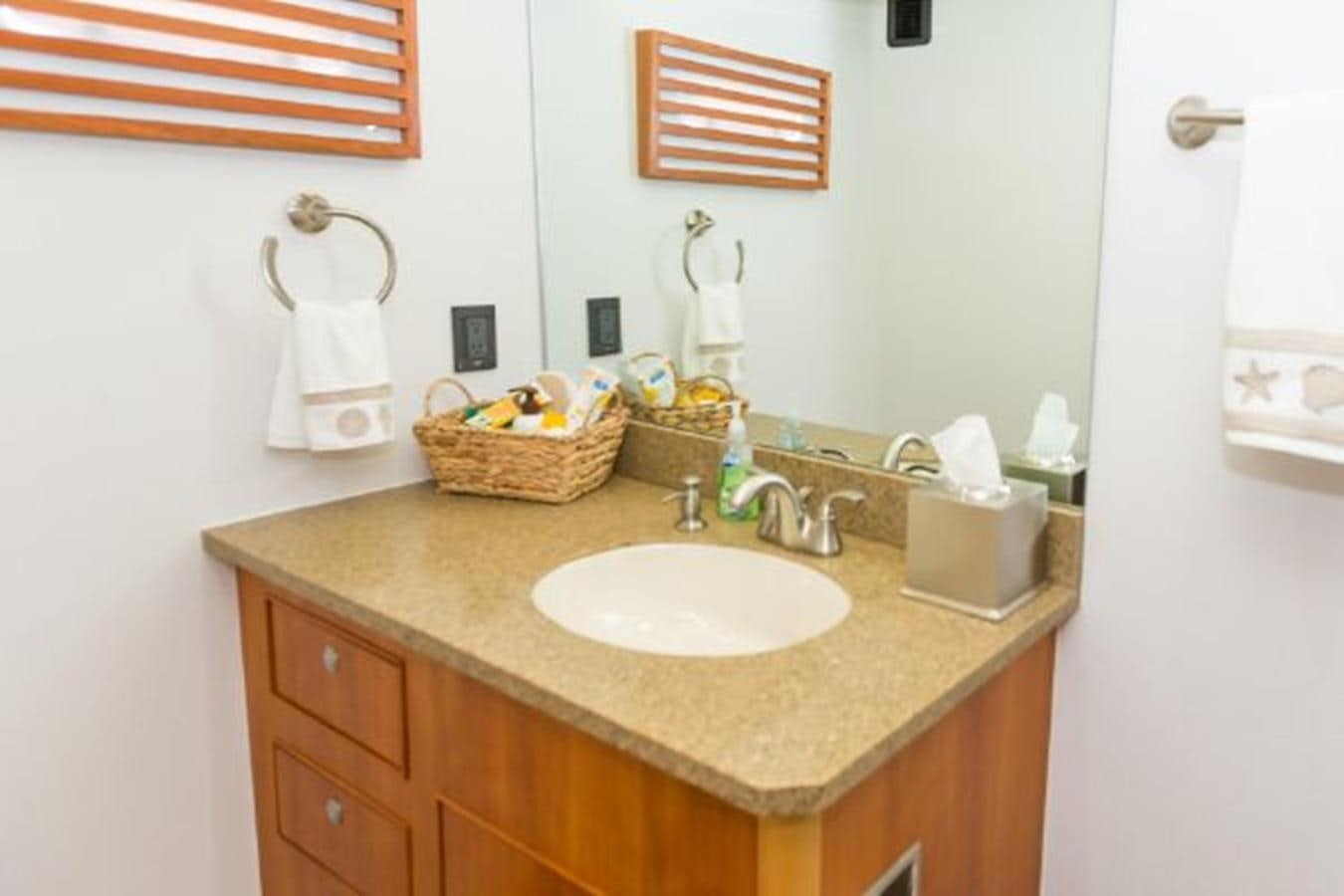 a bathroom with a sink and towels aboard ISLAND SOUL Yacht for Sale