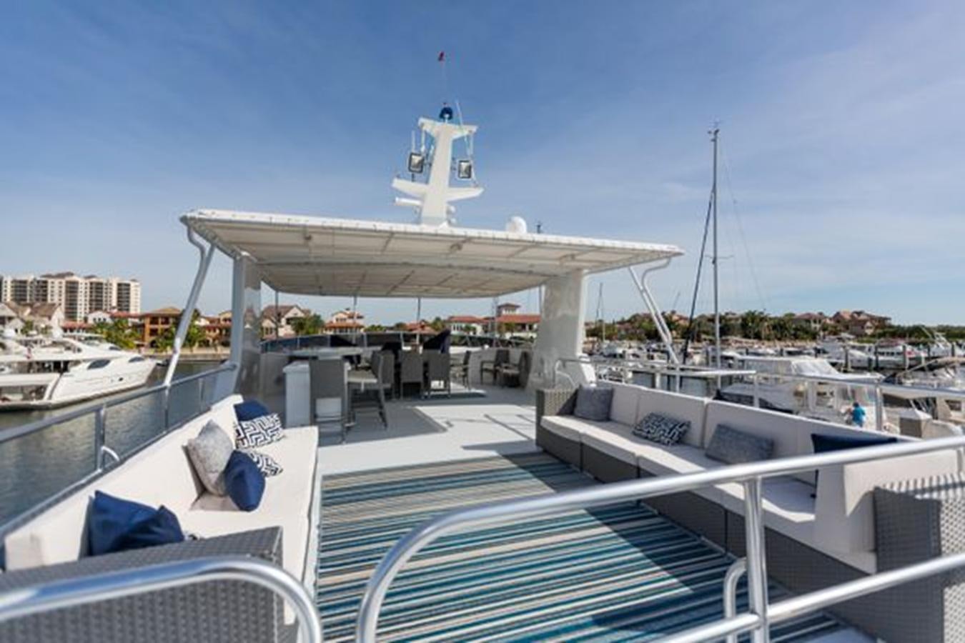 a large white building with a dome roof and a deck with chairs and a table and a blue aboard ISLAND SOUL Yacht for Sale