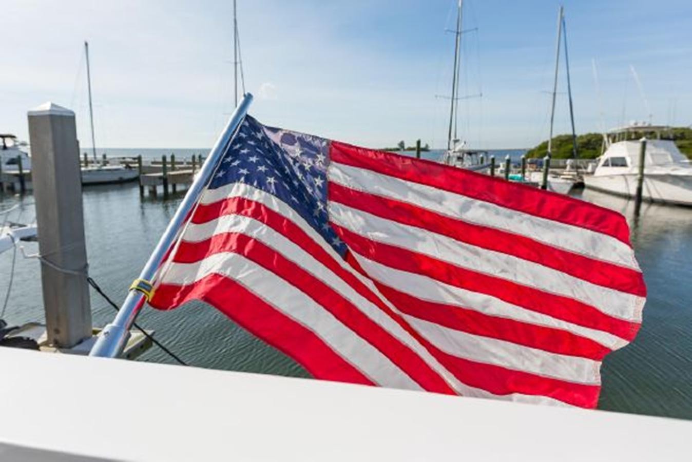 a red and white flag on a boat aboard ISLAND SOUL Yacht for Sale