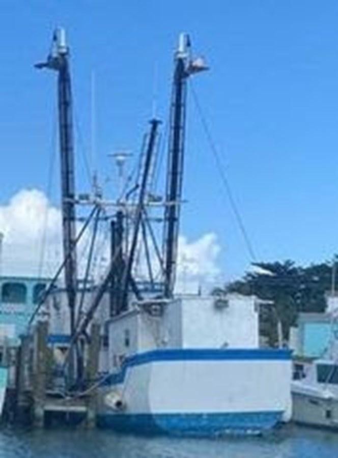 a large metal crane next to a boat aboard 1980 ST. AUGUSTINE 78 TRAWLER Yacht for Sale