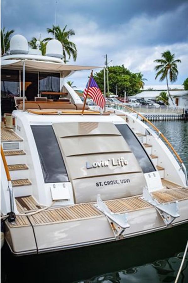 a boat with a flag on the deck aboard LOVIN LIFE Yacht for Sale