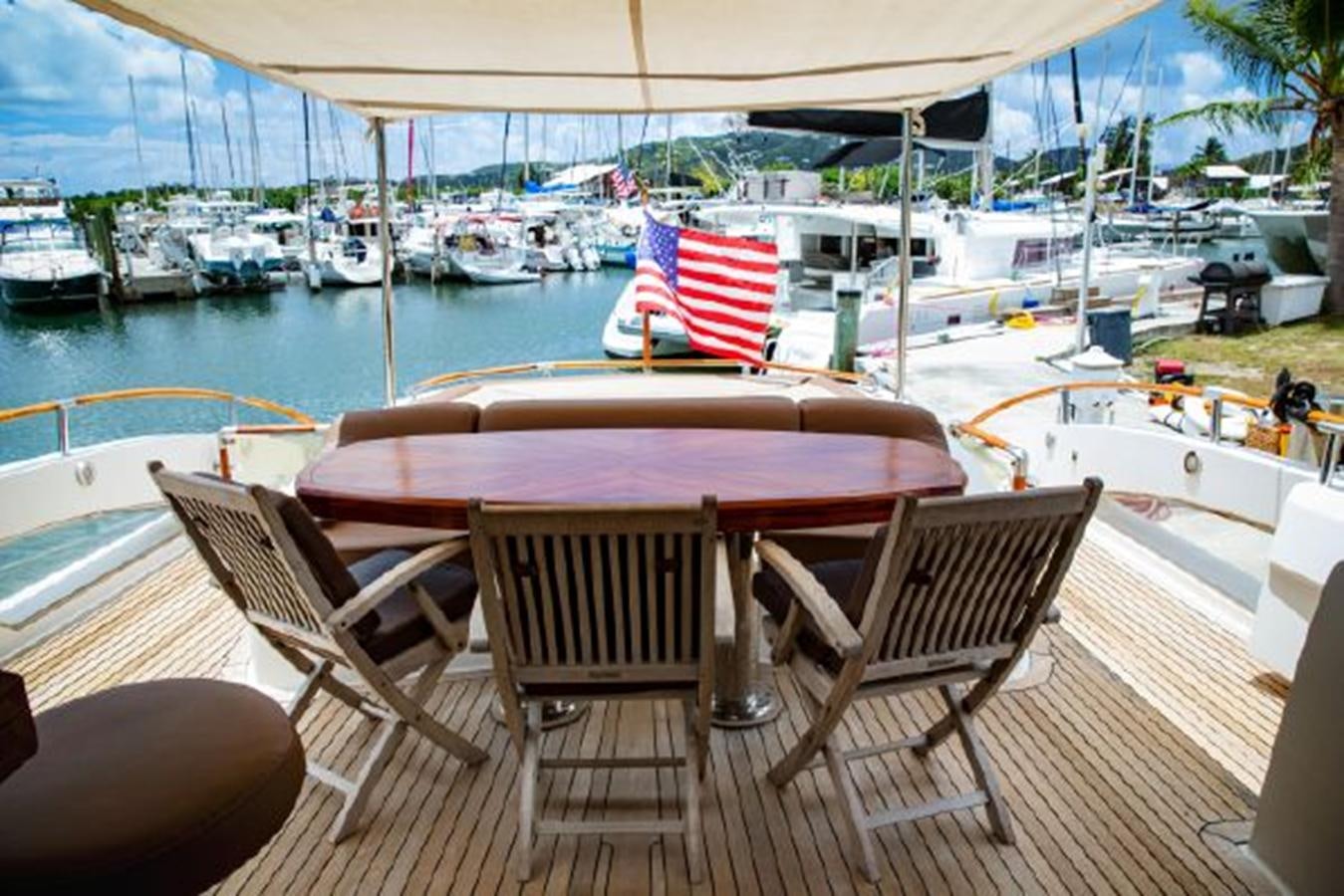 a table and chairs on a deck aboard LOVIN LIFE Yacht for Sale