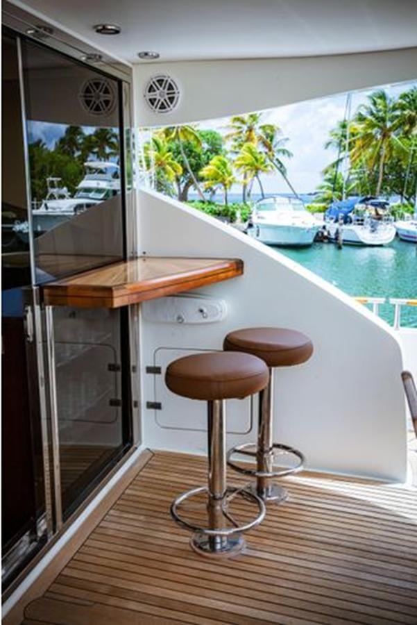 a kitchen with a table and stool aboard LOVIN LIFE Yacht for Sale