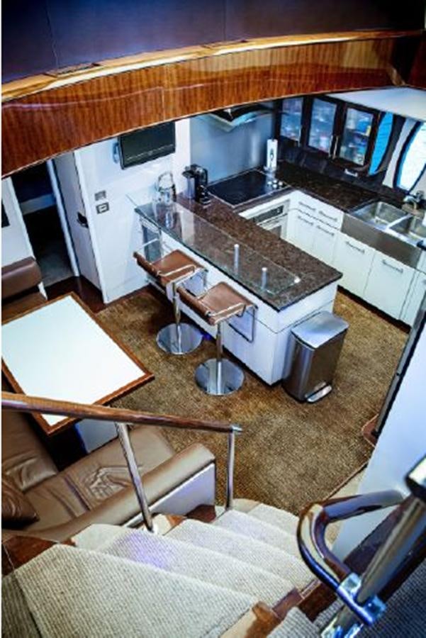 a kitchen with a bar and a table aboard LOVIN LIFE Yacht for Sale