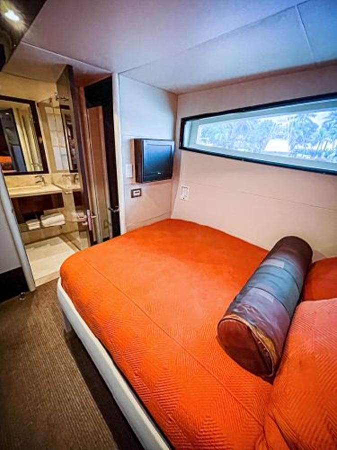 a living room with a couch and a tv aboard LOVIN LIFE Yacht for Sale