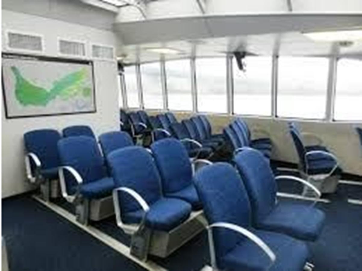 a room with blue chairs and a large screen aboard F350TXR Yacht for Sale