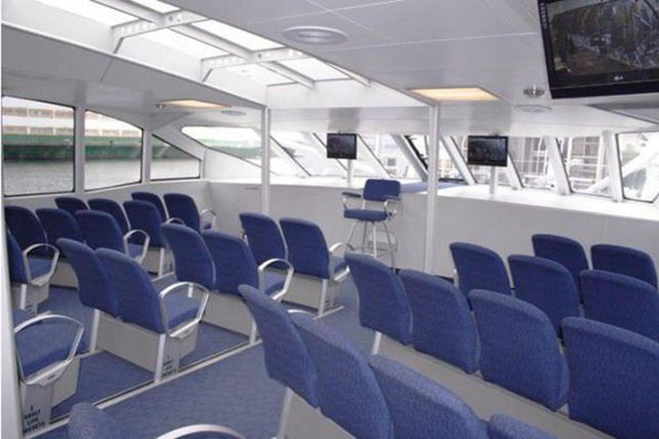 a room with chairs and a television aboard F350TXR Yacht for Sale
