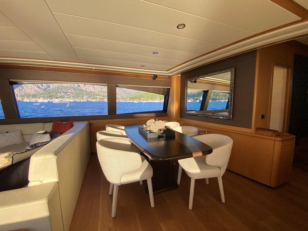 a room with a table and chairs aboard ADF Yacht for Sale