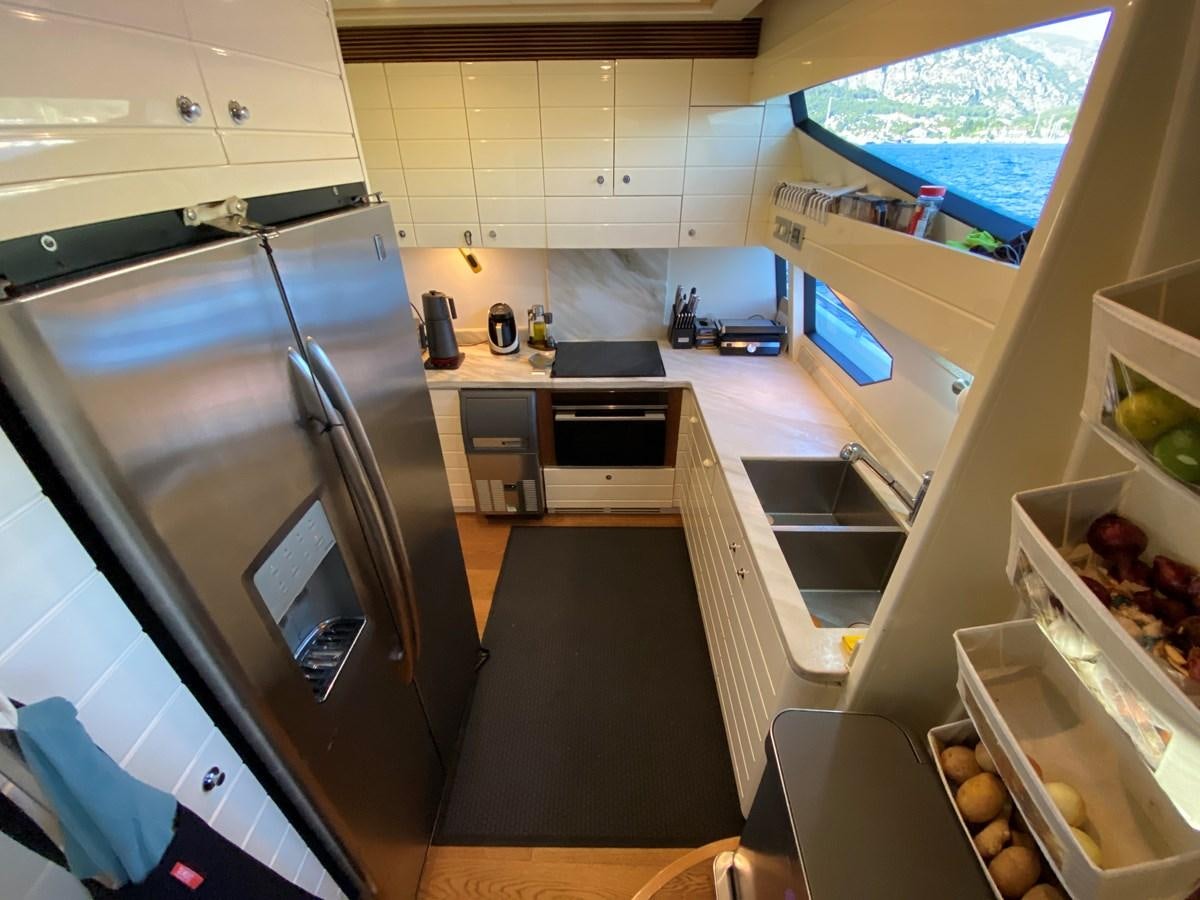 a kitchen with a large window aboard ADF Yacht for Sale